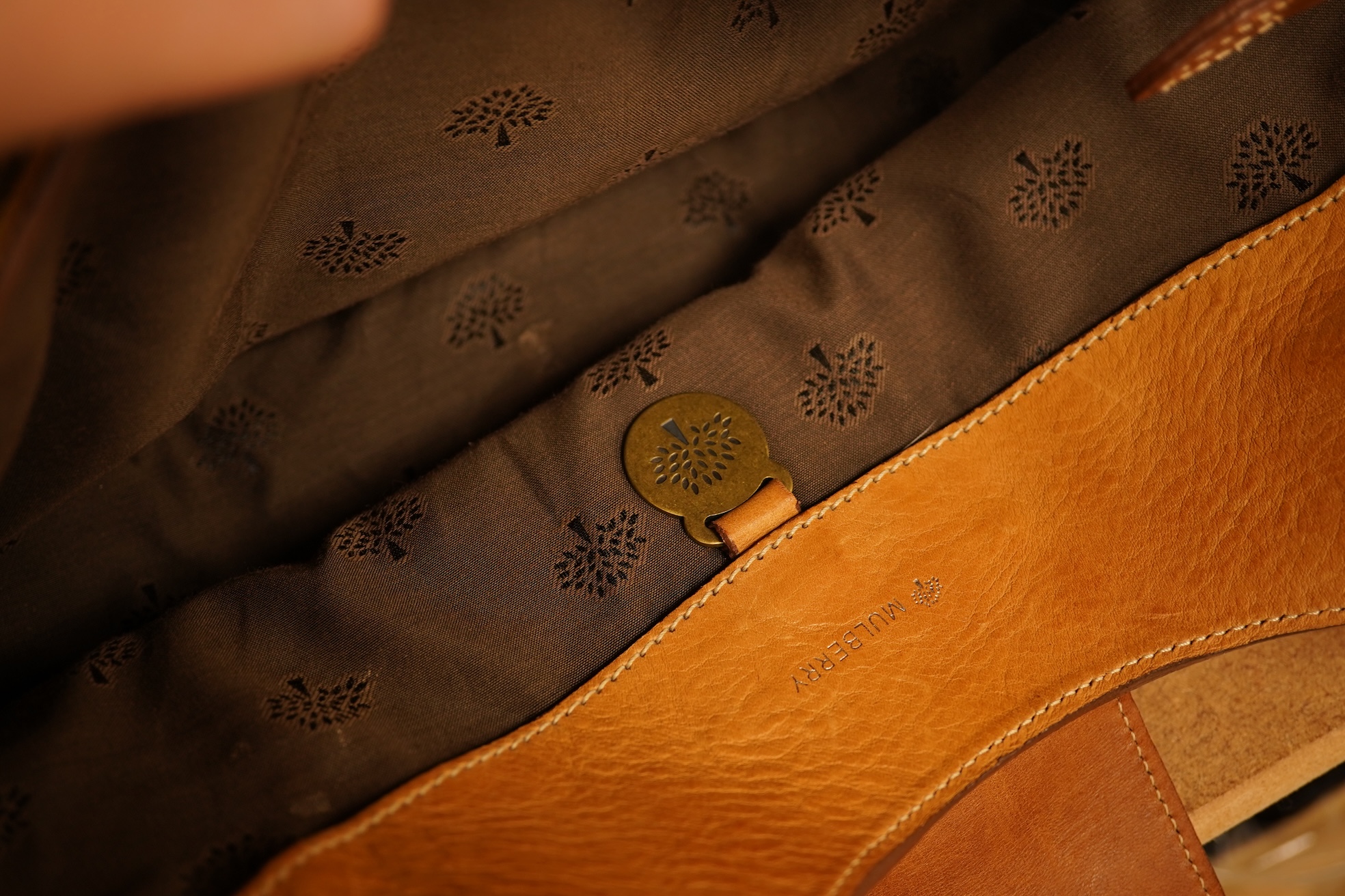 A Mulberry tote two zip, three postman clasps,tan leather with dark brown trim.handbag